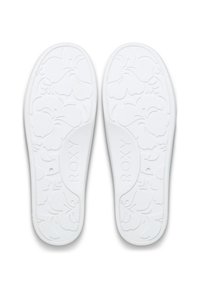 Semelles intérieures en caoutchouc blanc pour tongs avec un motif floral et le logo "ROXY" en relief. Texture lisse avec une forme profilée pour le confort.