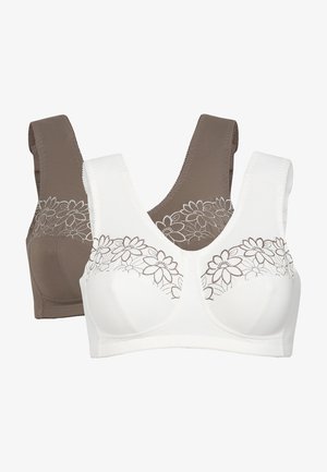Två bh:ar: en vit med blommig spetsdetalj på framsidan, en brun. Båda har breda axelband och en slät, elastisk textur.