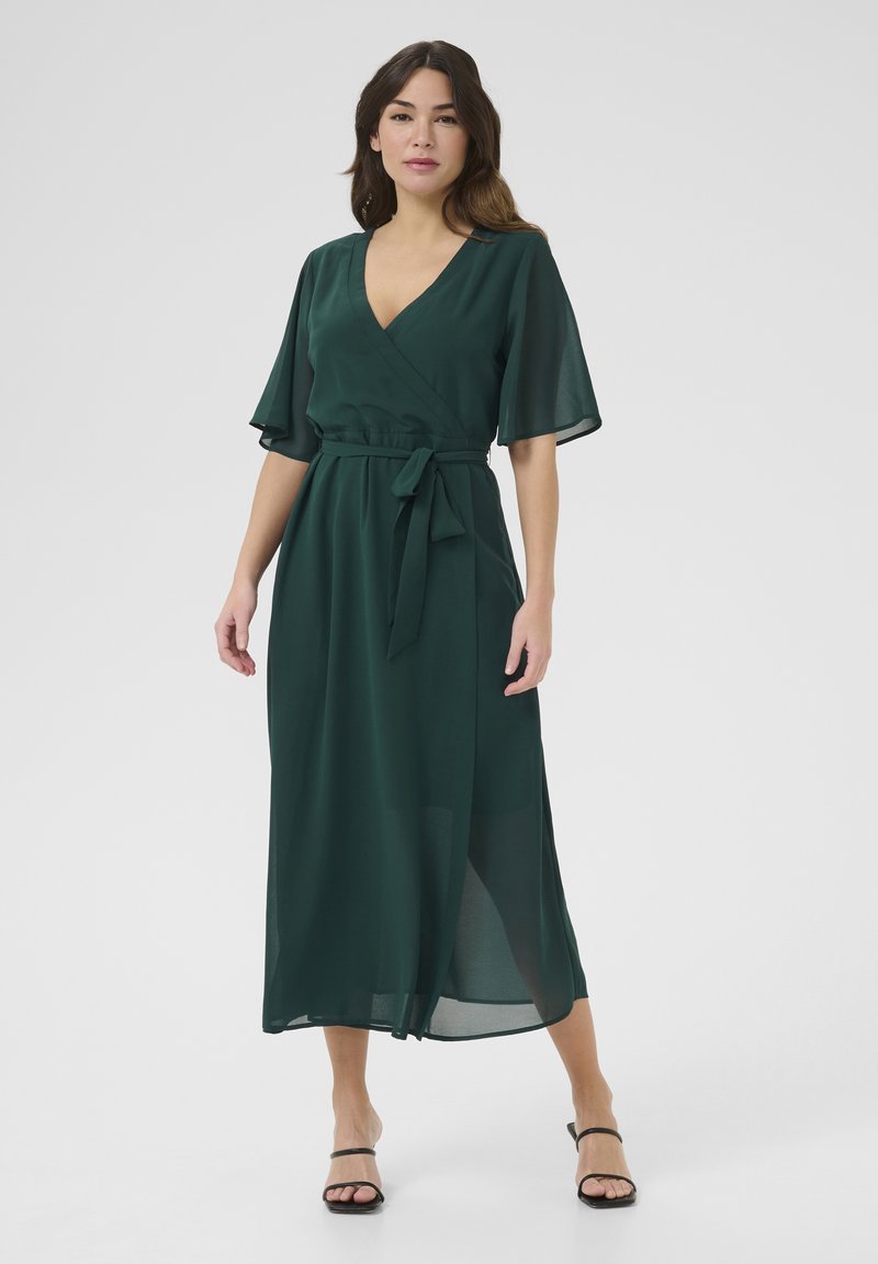 Green chiffon wrap dress with short flutter sleeves, a tie belt at the waist, and a flowing silhouette, featuring a mid-length cut.
