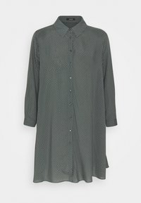 Dark green button-up shirt with long sleeves, featuring a white polka dot pattern, classic collar, and straight hem. Made of smooth fabric.
