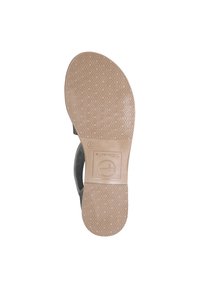 Suola della scarpa beige con un motivo esagonale; superficie liscia, punta arrotondata e dettaglio del marchio vicino al tallone. Texturizzata per la presa.