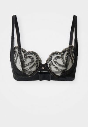 Reggiseno in pizzo nero con coppe in rete trasparente decorate con motivi ricamati a spirale e spalline sottili regolabili su sfondo bianco.