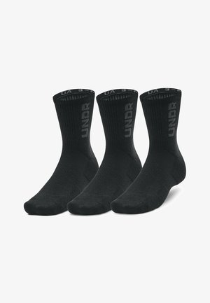 Chaussettes crew noires avec un haut côtelé, un orteil et un talon renforcés, avec le logo "UNDR" sur le côté. Le paquet comprend trois paires.