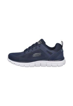 Zapatilla deportiva azul marino con suela blanca flexible, parte superior de malla, cordones, logotipo de la marca en el lateral y tira para tirar en el talón.
