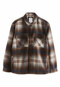 Veste en tartan marron et bleu, fabriquée en flanelle douce. Elle possède deux poches poitrine avec des fermetures à bouton et un col.