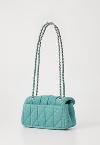 Quilted teal handbag with a structured shape, silver chain straps, and decorative accents. The surface has diagonal stitching patterns.