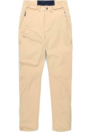 Pantaloni beige realizzati in tessuto morbido e leggero, con diverse tasche, tra cui una tasca laterale con zip, e un design aderente.