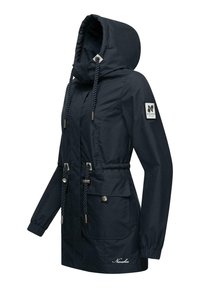 Navy blue waterproof jacket with a hood, drawstring waist, two front pockets, and logo patch on the sleeve. Smooth fabric and tailored design.