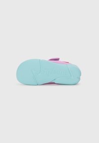 Colorful children's sandal featuring a pink upper, blue rubber sole with textured pattern, and adjustable straps for a secure fit.