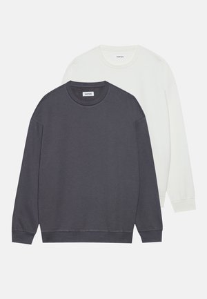 Two crewneck sweaters in dark gray and white, made from soft cotton, featuring long sleeves and ribbed cuffs and hem.