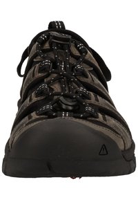 Czarne buty trekkingowe z teksturowaną gumową podeszwą, elastycznym systemem sznurowania oraz materiałową cholewką z wentylowanymi sekcjami dla lepszej oddychalności.