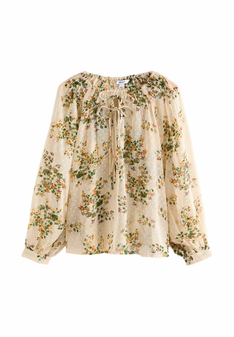 Blouse en crépon crème avec imprimé floral vert et jaune, manches longues bouffantes, poignets élastiques et col avec un nœud à nouer.