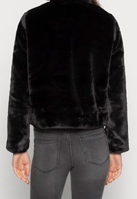 Black faux fur jacket with a cropped design and long sleeves. Features a soft, plush texture and no visible embellishments or hardware.