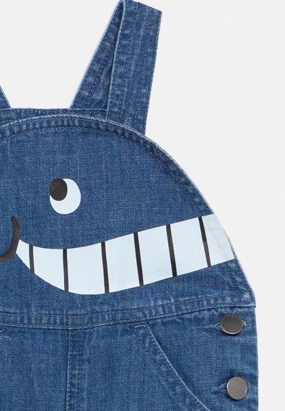 Τζιν σαλοπέτα με ράνερ που διαθέτει γραφικό με χαμογελαστό πρόσωπο φάλαινας με μεγάλα μάτια και λεπτομέρειες με δόντια.