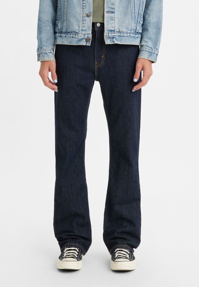 Dark blue denim jeans with a straight-leg cut. Features a classic five-pocket design, orange stitching, and a zipper fly.