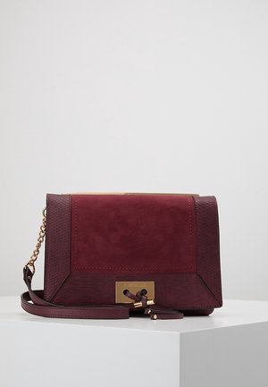 Rectangular burgundy handbag with suede center, textured sides, gold chain strap, and gold rectangular clasp with decorative knots.