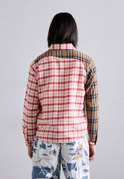 Red and white checked flannel shirt with a brown and green plaid shoulder panel. Features long sleeves and a classic collar.