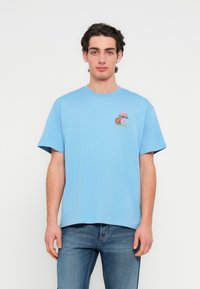 Ανοιχτό μπλε βαμβακερό μπλουζάκι με κοντά μανίκια και στρογγυλή λαιμόκοψη. Διαθέτει πολύχρωμο κεντητό σχέδιο με λουλούδια και μπάλα μπάσκετ στο αριστερό στήθος.