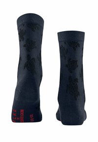 Calzini blu navy con un motivo di tartaruga nera, polsini a coste e testo rosso sulla parte inferiore. Progettati per comfort e stile.