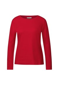 Röd långärmad topp i ribbad tyg, med rund halsringning och knappdekorationer på ärmsluten. Slät yta, figurnära design.