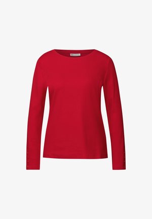 T-shirt rouge à manches longues en tissu côtelé, avec un col rond et des accents de boutons sur les poignets. Texture lisse, design ajusté.