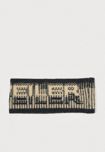 Bandeau tricoté en crème et bleu foncé, présentant un motif géométrique répétitif. Texture douce avec un design côtelé sur les bords.