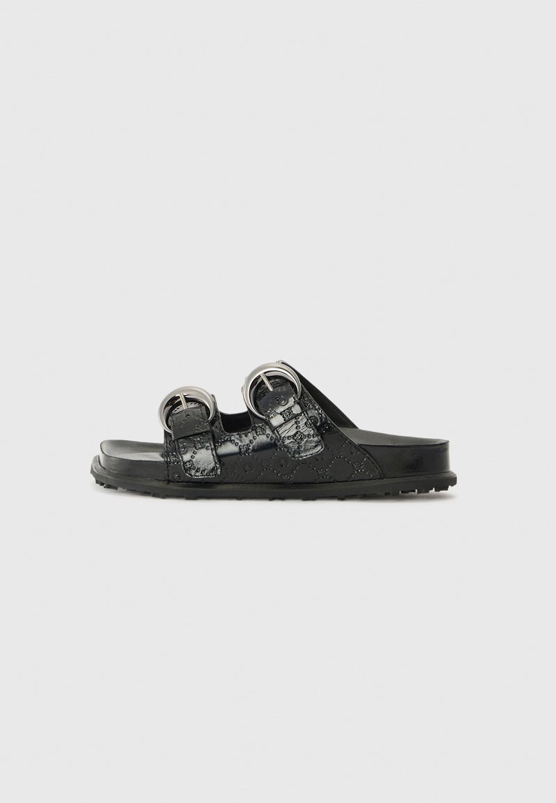 Black sandals with a glossy finish, featuring two adjustable buckle straps and a textured pattern on the upper. Flat rubber sole.