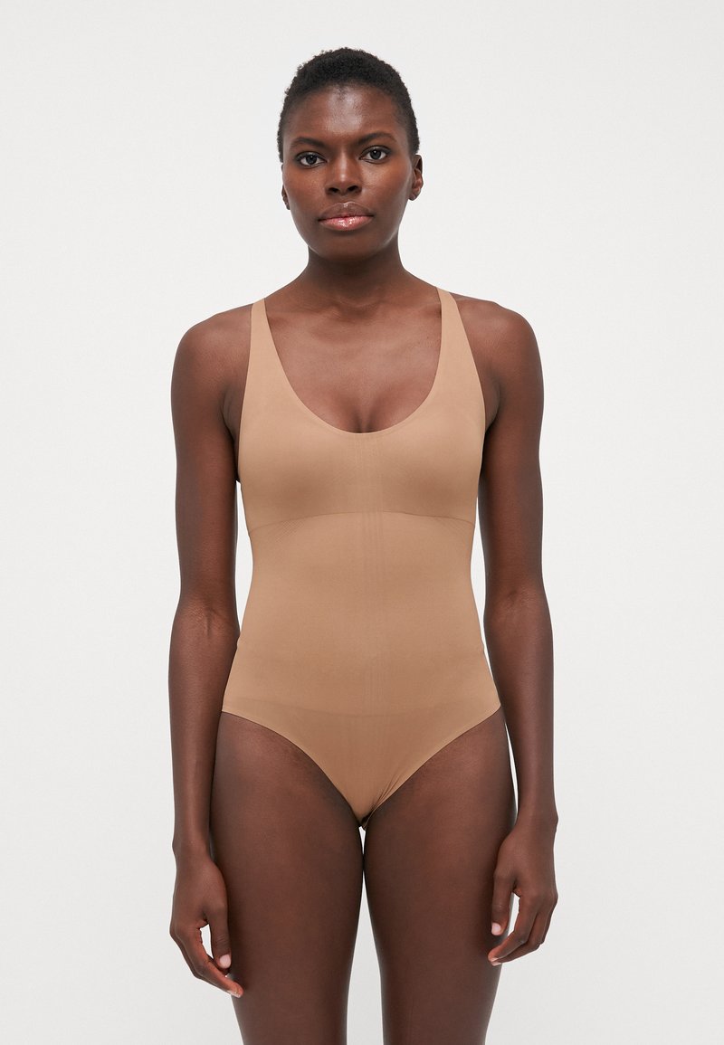 Tan bodysuit met een diepe scoopneklijn, brede schouderbanden en een gladde textuur. Kenmerkt een aansluitende silhoutte met minimale stikseldetails.