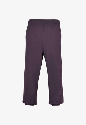 Violeta, īsi sporta bikses ar elastīgu jostu un elastīgām maliņām. Izgatavotas no mīksta auduma, ar gludu tekstūru un minimālām šuvēm.