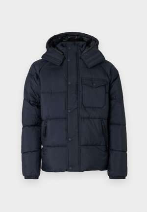 Sötétkék kapucnis steppelt dzseki cipzáras zsebbel, gombos záródással és bordázott mandzsettákkal. Csillogó, texturált anyagból készült.