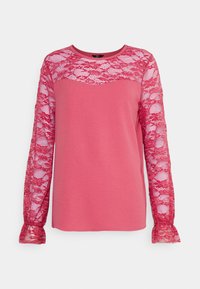 Blusa de manga longa rosa com um sobreponto de renda texturizada nas mangas, decote redondo e punhos de renda com babados. Tecido suave com um acabamento liso.