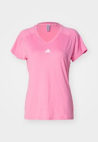 Pink athletic T-shirt with short sleeves, v-neckline, and a white logo on the chest. Fabric appears smooth with a lightweight texture.