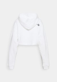 Sweat à capuche blanc court avec manches longues et capuche, avec un petit logo noir The North Face en haut à droite du dos.