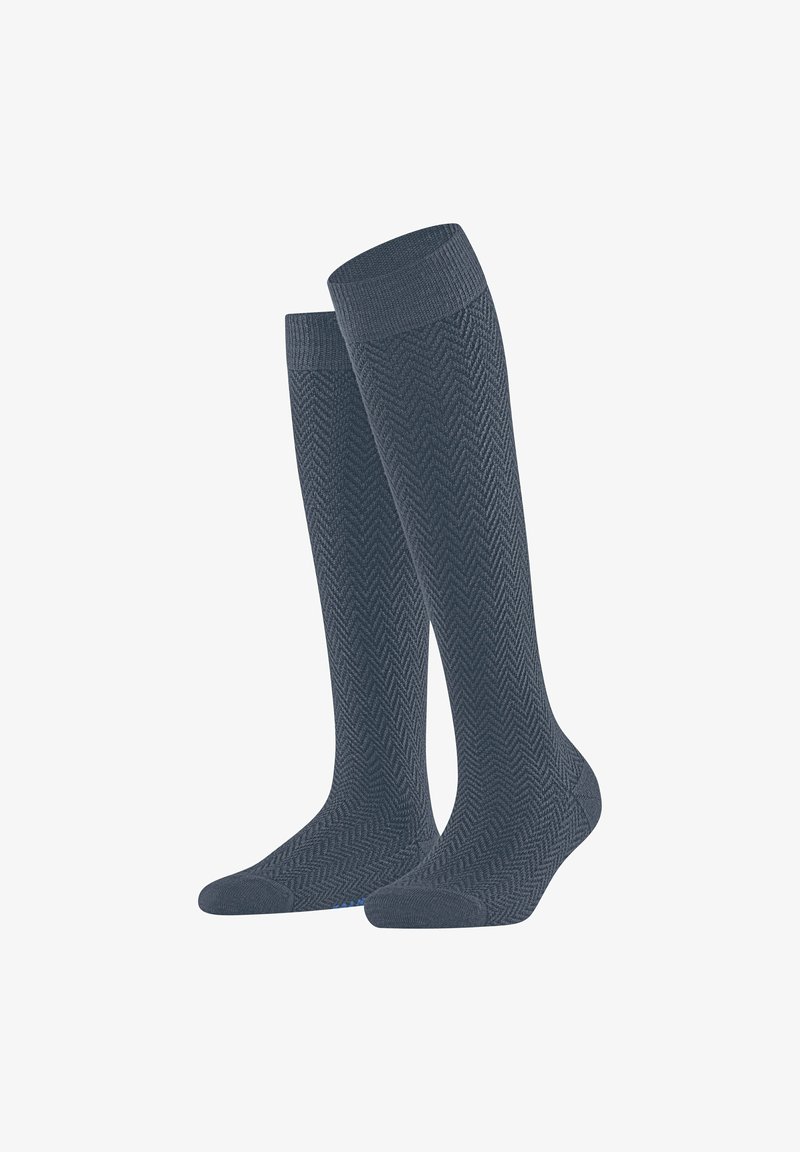 Calze al ginocchio di colore grigio scuro con motivo a spina di pesce, dotate di bordo a coste e finitura liscia. Costruzione durevole per il comfort.