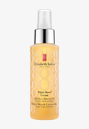 Clear spray bottle of Elizabeth Arden Eight Hour Cream All-Over Miracle Oil for face, body, and hair with a silver pump and yellow liquid inside.