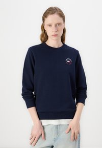 Sudadera azul marino de mezcla de algodón, con cuello redondo, puños acanalados y un detalle de logo bordado en el pecho.