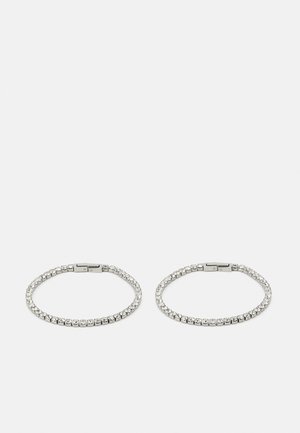 Silver metal hoops adorned with clear rhinestones. The design features a flexible band with a clasp closure, showcasing a uniform pattern of stones.