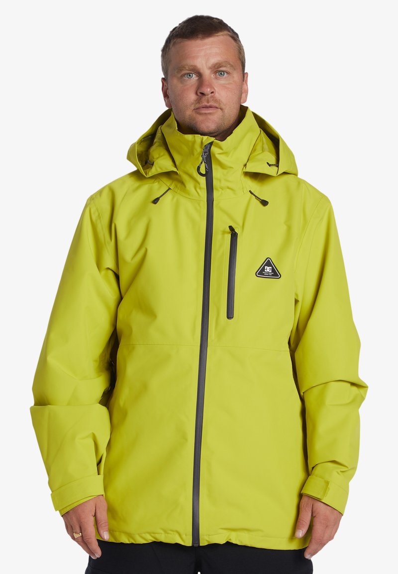 Bright yellow waterproof jacket with a hood, featuring a front zipper, chest pocket, and a logo patch. Smooth texture and loose fit.