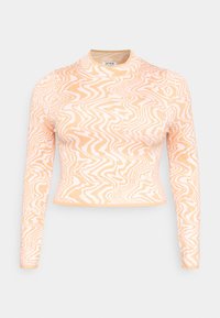 Top cropped de manga longa em pêssego com padrão de ondas brancas. Textura suave com design de gola alta. Tecido elástico para conforto e ajuste.