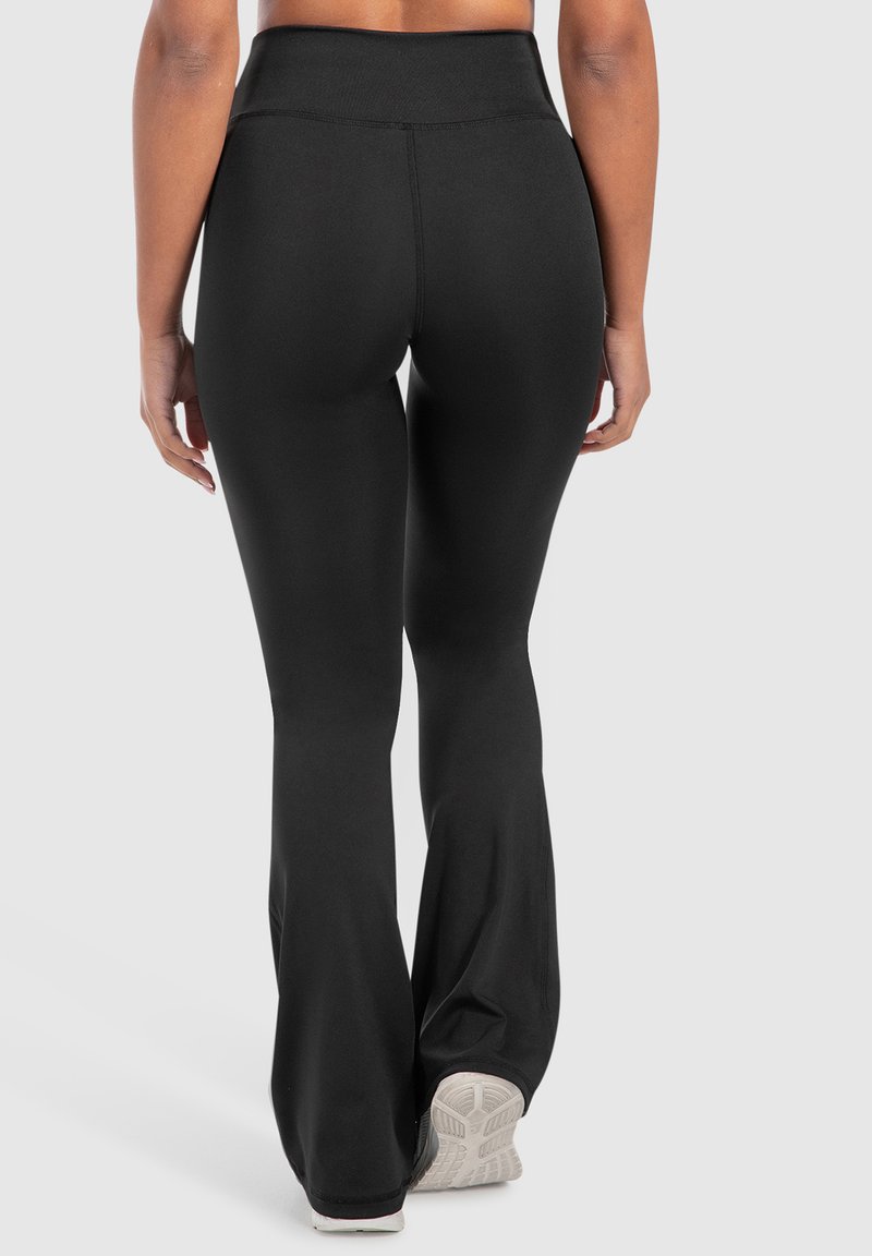 Leggings neri a palazzo realizzati in materiale elasticizzato. Vita alta, design senza cuciture e tessuto testurizzato. Adatti per l'abbigliamento sportivo.