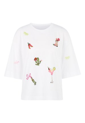 White short-sleeve shirt with colorful embroidered designs: chili peppers, cowboy boot with flowers, cactus, cocktail, lime slices, and lipstick with "Smile" text.