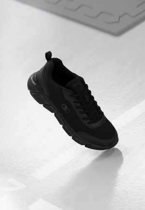 Black athletic shoe featuring mesh material, lace-up design, textured sole, and logo detail on the side. Appears lightweight and flexible.