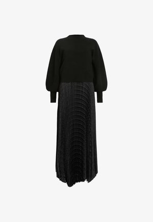 Suéter negro con mangas abullonadas combinado con una falda negra con plisados que presenta una textura sutil. Diseño largo y fluido con una silueta elegante.
