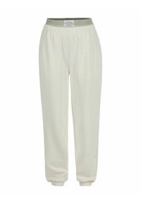 Cremfarbene Jogginghosen mit einem gerippten grünen Bund, elastischen Bündchen und Seitentaschen; aus weichem, leichtem Stoff gefertigt.