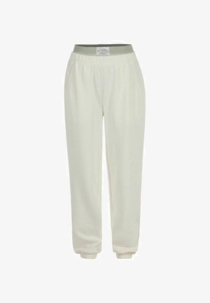 Pantaloni jogger color crema con vita a costine verde, polsini elasticizzati e tasche laterali; realizzati in tessuto morbido e leggero.