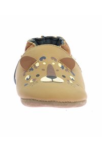 Chaussure en cuir tanné à enfiler conçue pour les enfants, présentant un visage de lion imprimé avec des oreilles, des accents marron et or, et une semelle douce.