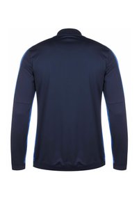 Langärmliges Sporthemd in Marineblau mit hellblauen Seitenstreifen. Weicher, glatter Stoff mit Kragen und elastischen Bündchen.