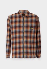 Checkered zip-up shirt in orange, brown, and blue. Features a collar, long sleeves, and a small logo on the chest pocket. Soft fabric texture.