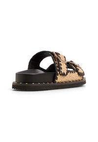 Woven straw slide sandal with black edges, dual adjustable straps, a solid black sole, and decorative metal hardware. Low-profile design.