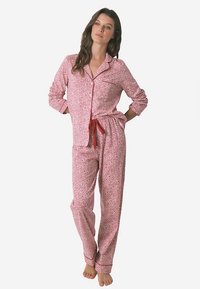 Red and pink floral print pajama set with long sleeves, button-up shirt, and drawstring pants, made of soft fabric. Accented with red ties.